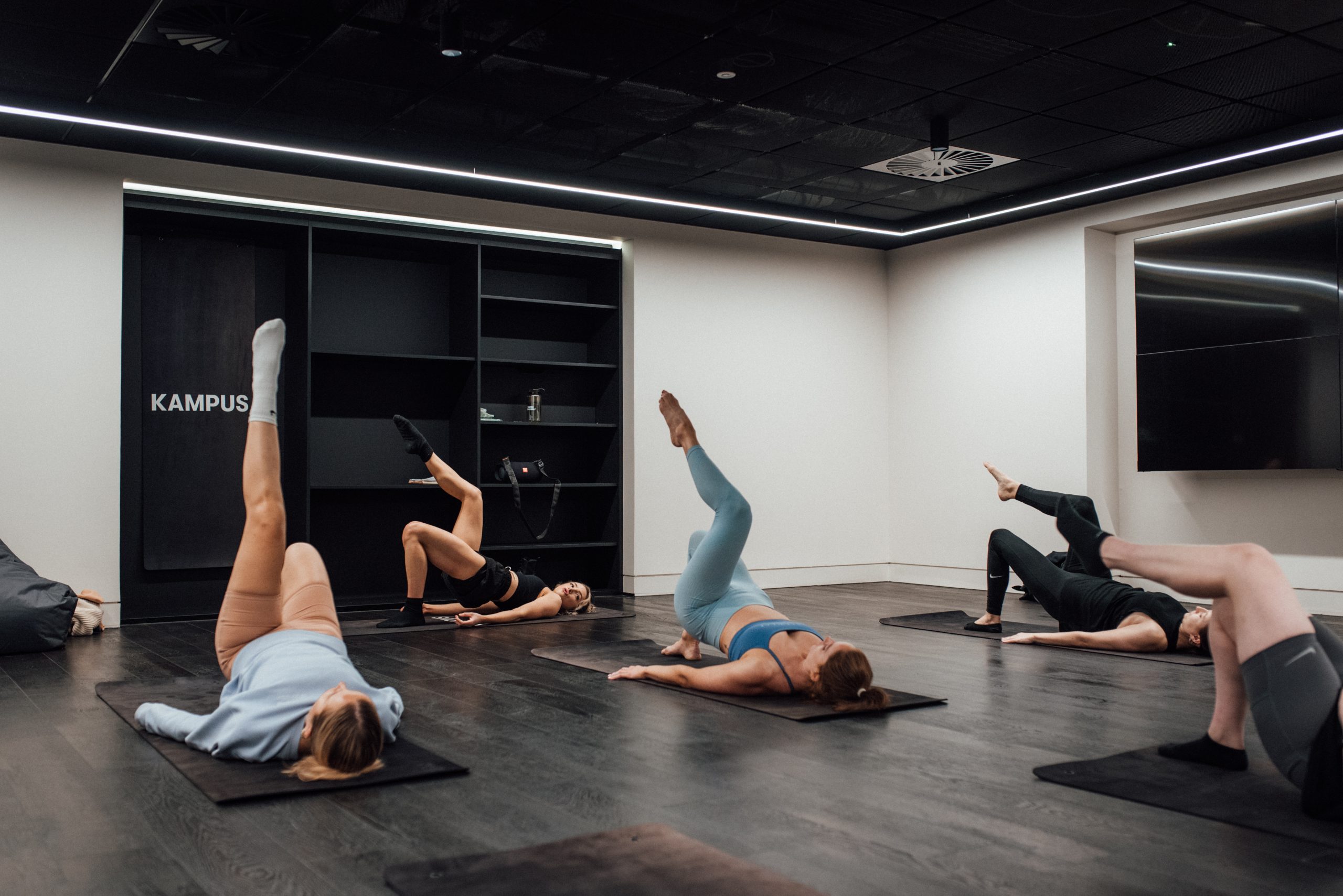 A group yoga session inside the Kampus gym